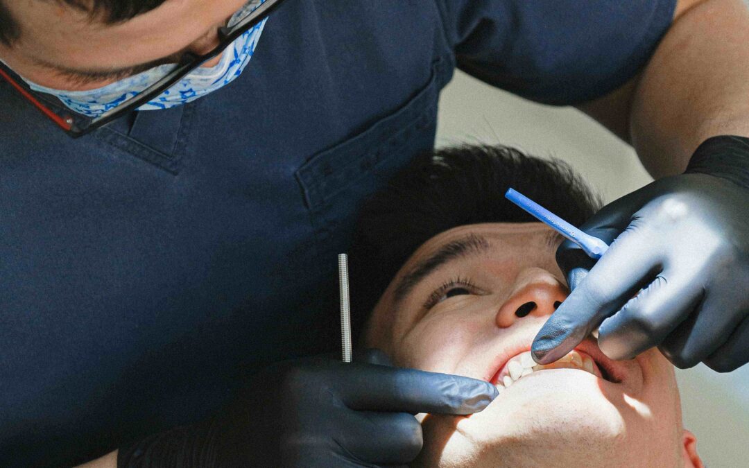 Dentist checking patient's teeth for cosmetic dentistry procedure